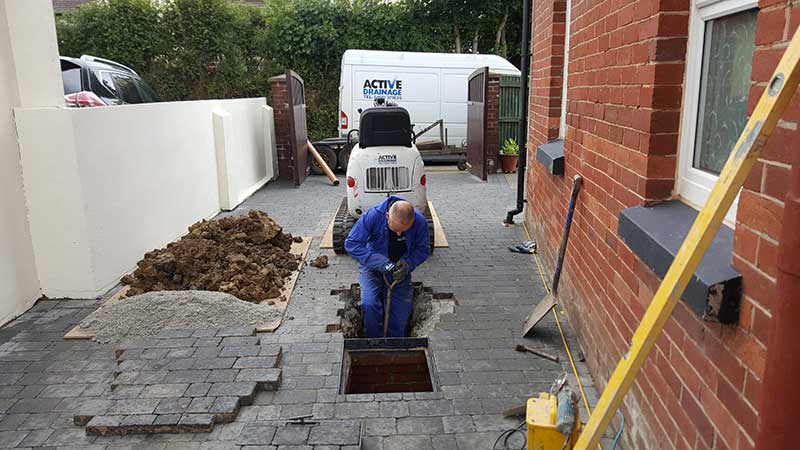 Man repairing a drain